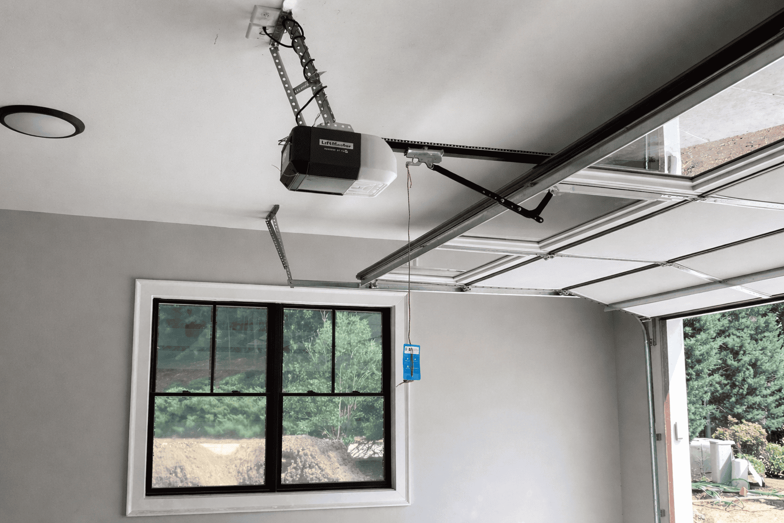 Garage door opener repair service by Elving Heating and Cooling in a modern garage.